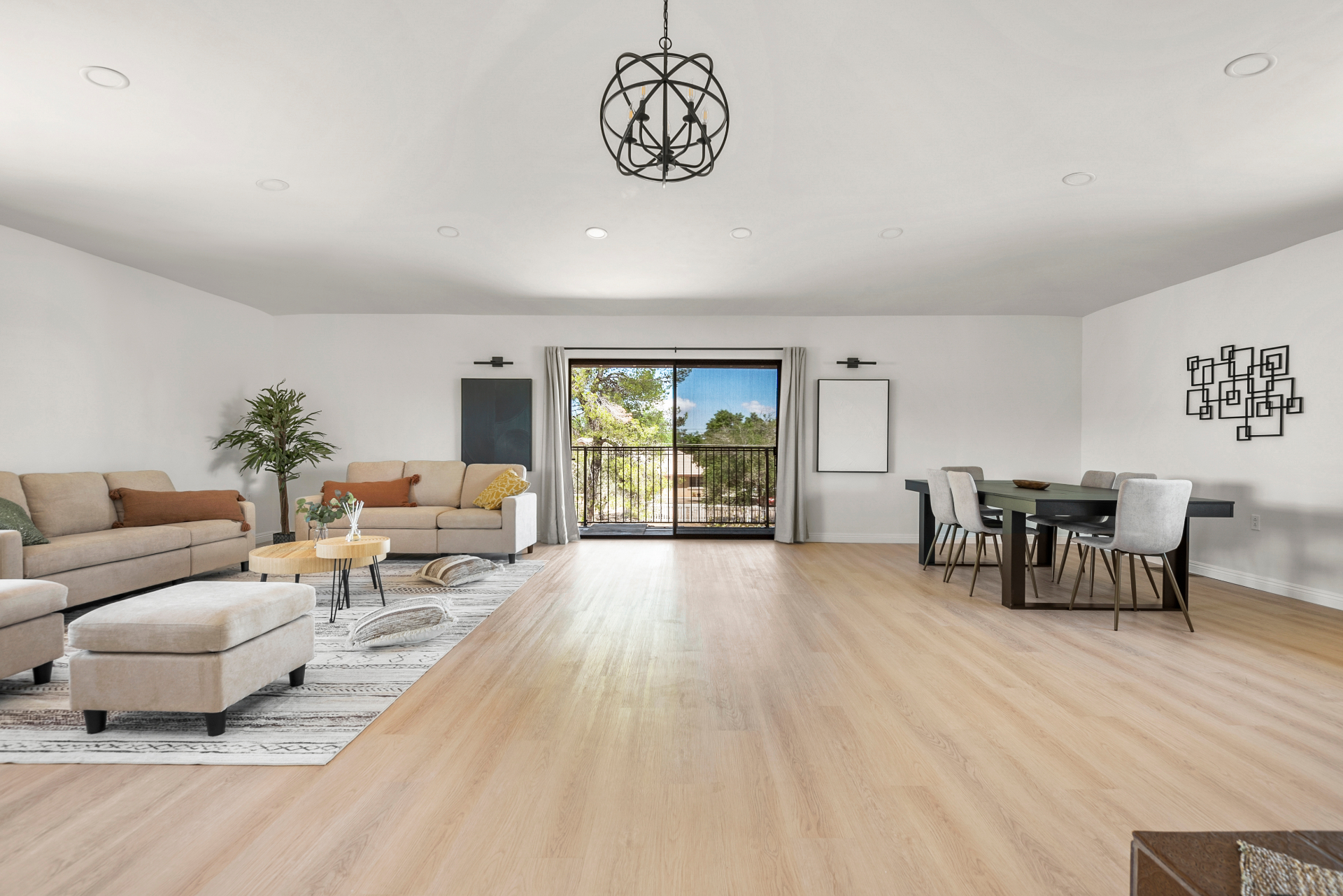 Light-filled great room at Hesperia Assisted Living with wood floors and an open balcony view